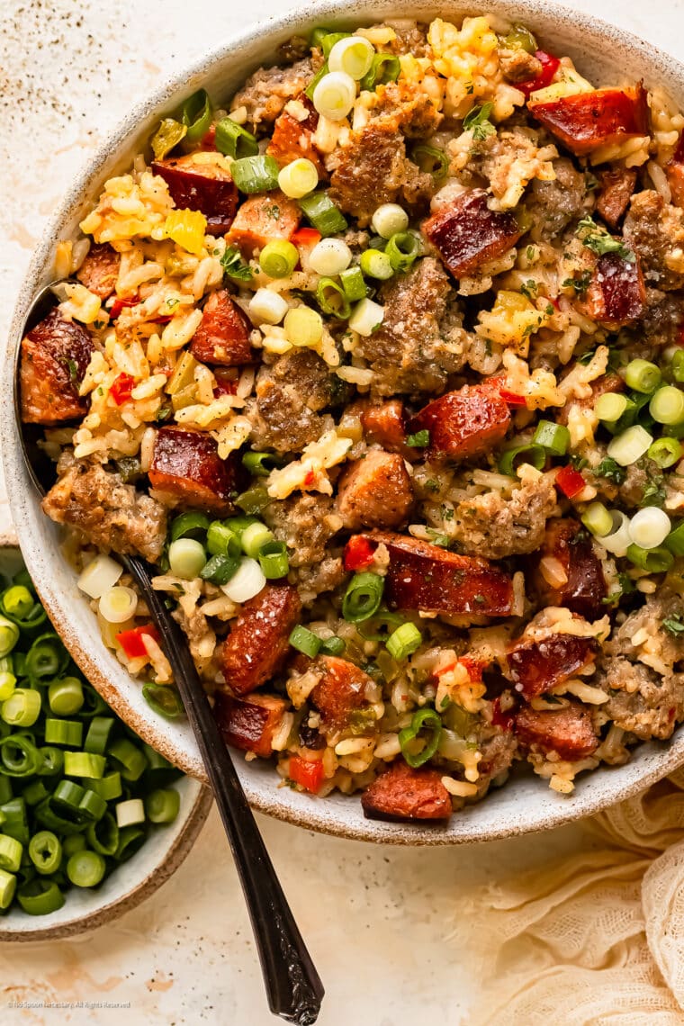 Overhead photo of cajun dirty rice with beans and sausage in a white bowl.