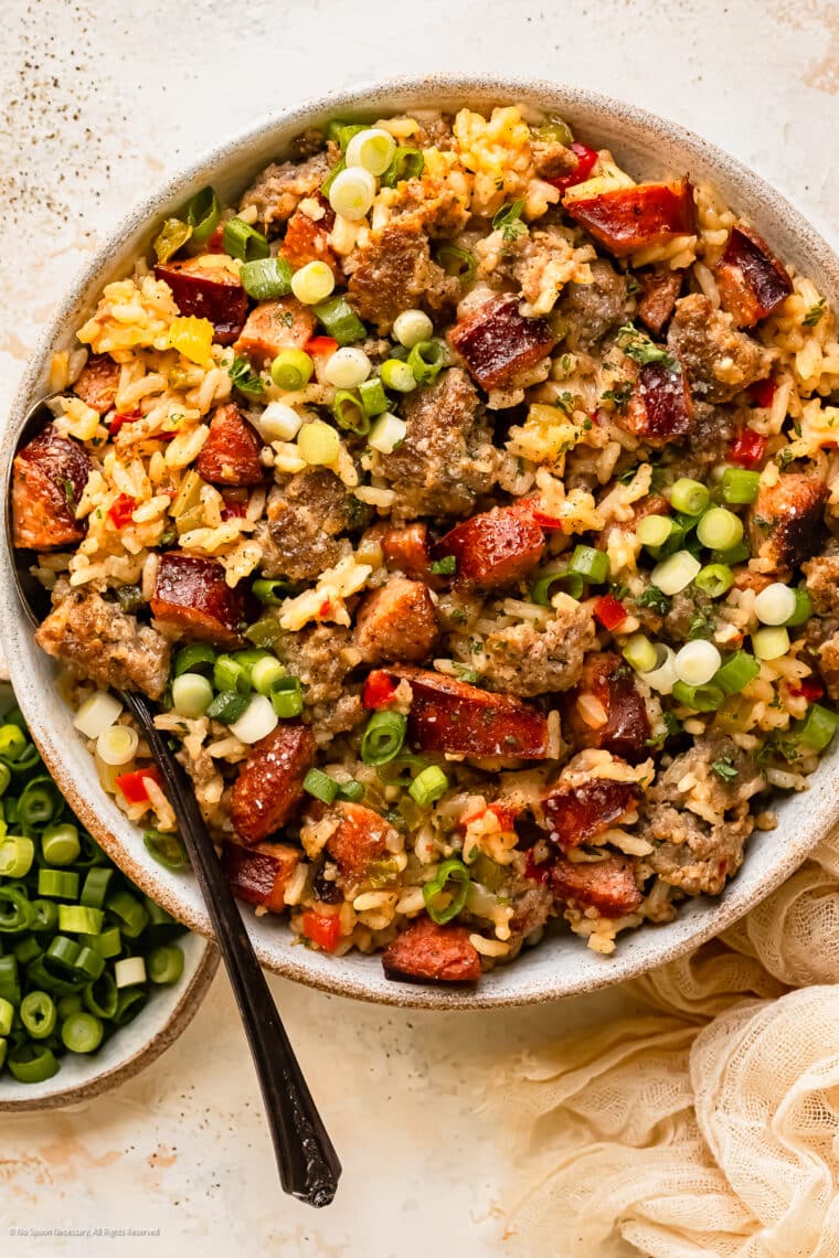 Overhead photo of a bowl of dirty cajun rice with sausage and bell peppers.