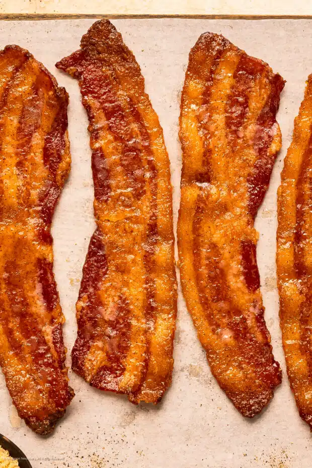 Overhead photo of two strips of maple candied bacon.