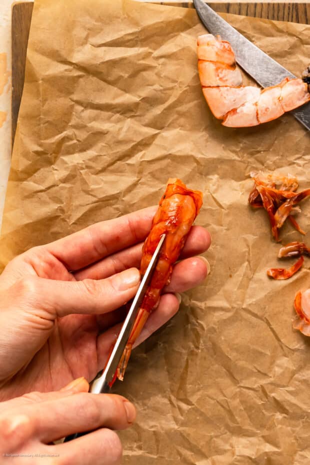 Action photo of a person cleaning a shrimp