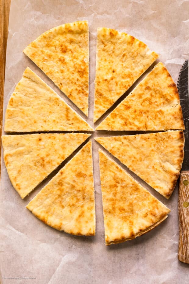 Overhead photo of a pita bread cut into triangles.