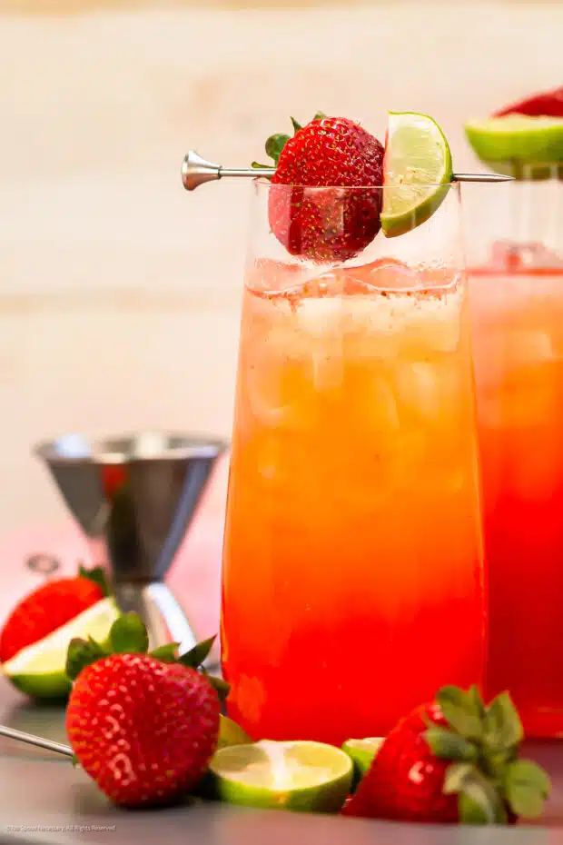 Photo of an alcoholic drink with strawberry vodka and fresh strawberries.