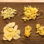 Overhead photo illustrating how to cut garlic five different ways - sliced, chopped, minced, grated, and as a paste.