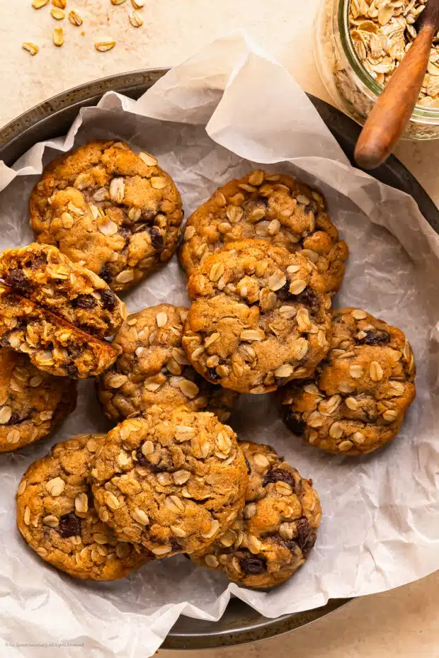 Overhead photo of ten soft raisin oatmeal cookies in a cookie tin.