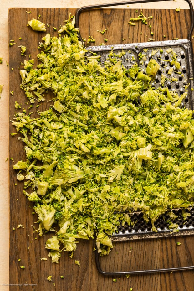Overhead photo of how to make broccoli rice with a box grater.