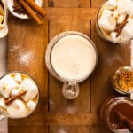 Overhead photo of three cups of hot chocolate with white chocolate, vanilla, and cinnamon.