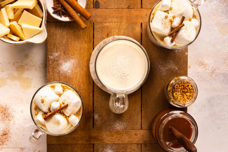 Overhead photo of three cups of hot chocolate with white chocolate, vanilla, and cinnamon.